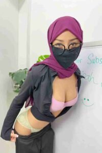 Malaysia Escort Girl Woman in hijab, mask, and lingerie poses near whiteboard. Sex Service Kuala Lumpur