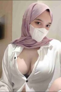 Malaysia Escort Girl Woman in hijab and mask wearing an unbuttoned white shirt. Sex Service Kuala Lumpur