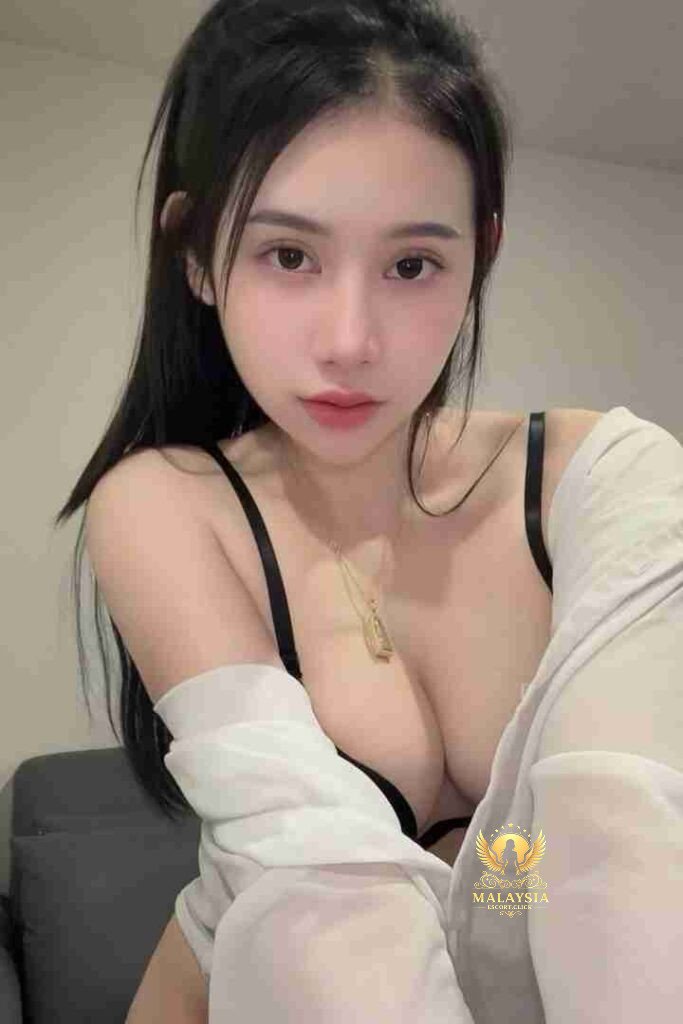 Beautiful Asian woman in black bra and white shirt. Gold necklace. Dark hair. Portrait.