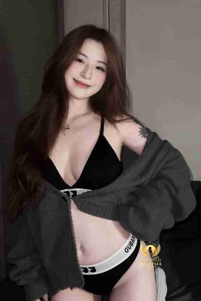 Smiling Asian woman in lingerie and cardigan. Yu Xin KL call girl.