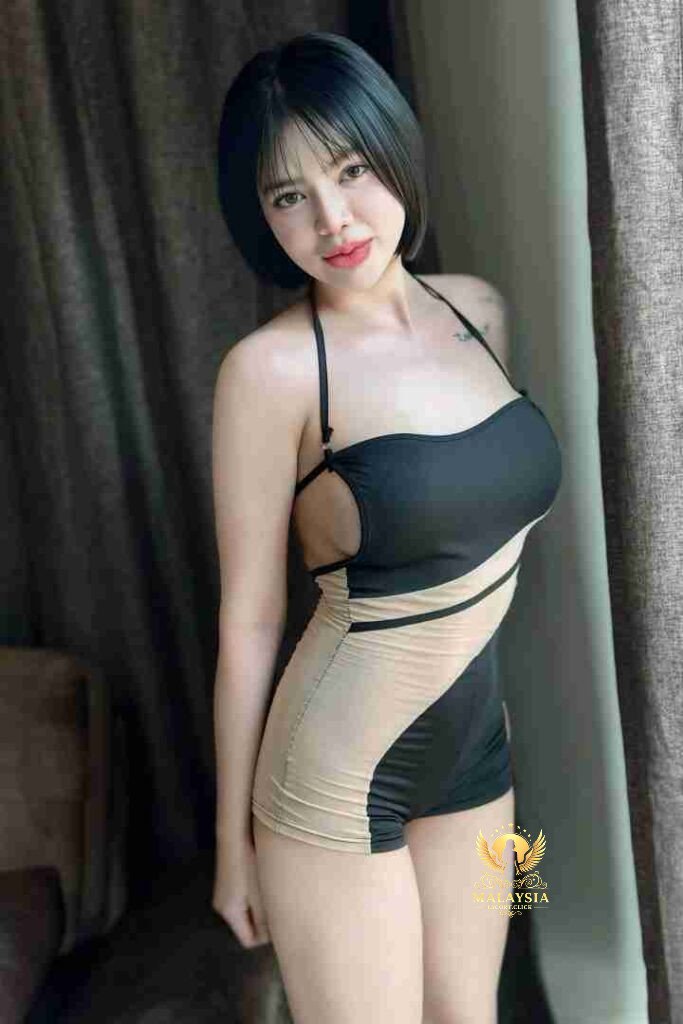 Attractive Asian woman in stylish black and beige swimsuit posing near window. Bob haircut, confident gaze.