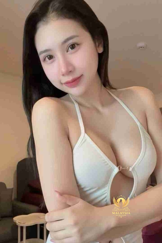 Attractive Asian woman in white halter top, smiling at the camera. Beauty portrait.