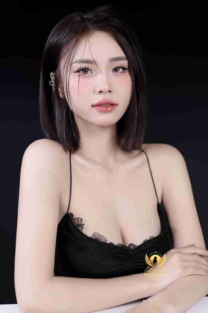 Luxury KL escort Elite Celina, 23yo, in black dress. C cup sophistication, VIP incall/outcall Kuala Lumpur.