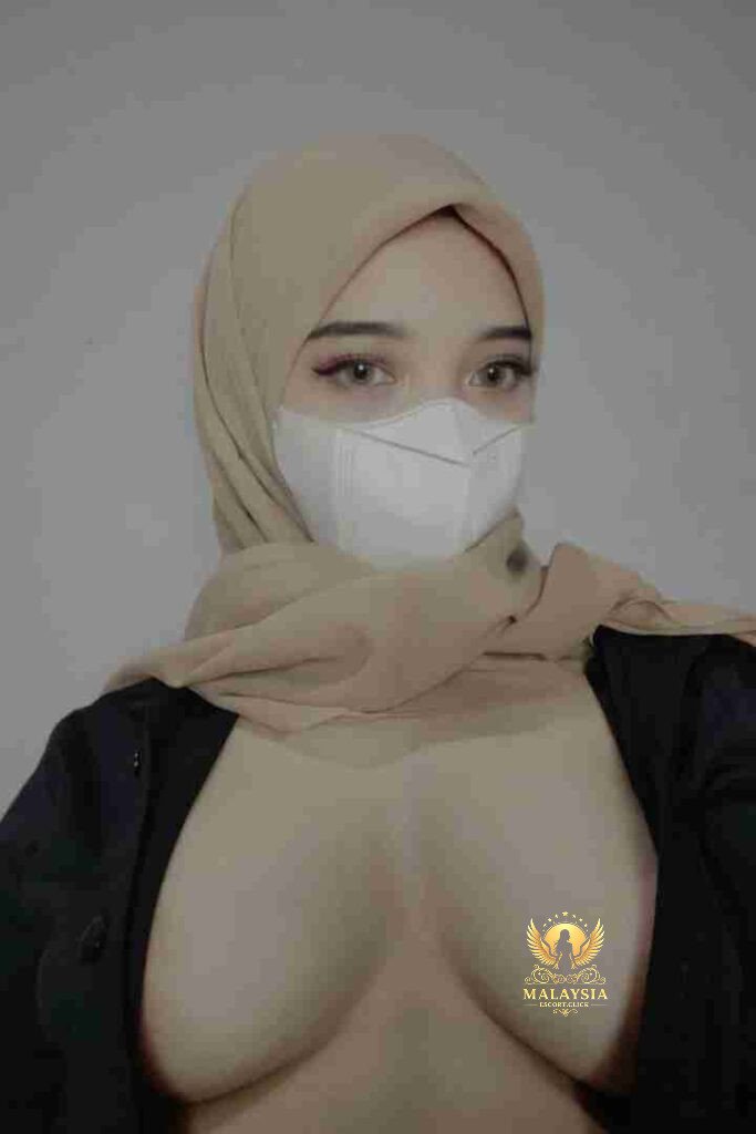 Malay woman in hijab and mask, low-cut top. Enigmatic Zara, incall/outcall in KL.
