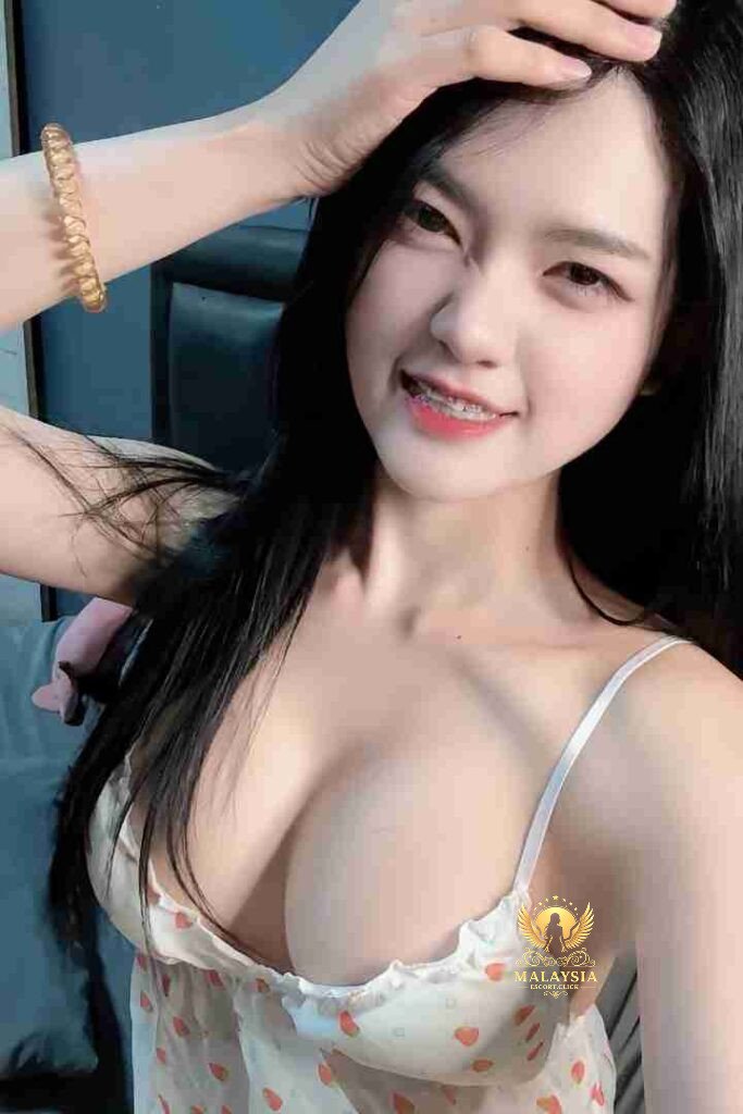 Smiling Asian woman with braces, wearing a white top. Alluring beauty.