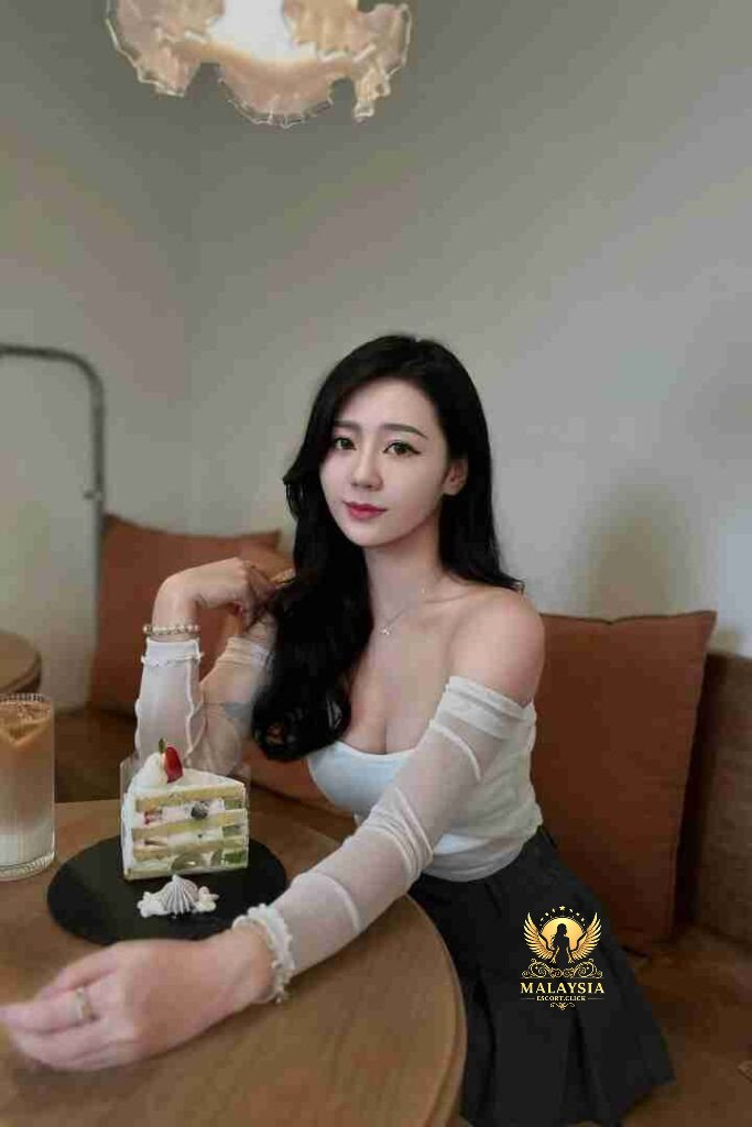 Elegant woman with dessert in cafe. Black hair, off-shoulder top, cake with fruit.