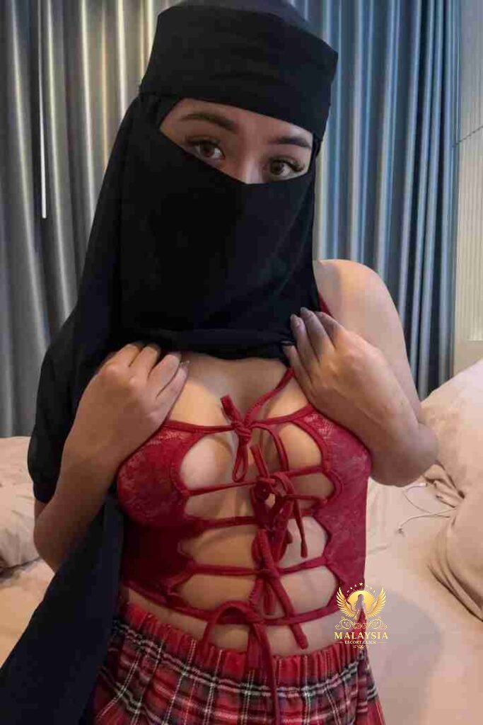 Malaysia Escort Girl Portrait of a woman with dark hair wearing a white top that says "Baddie. Sex Service Kuala Lumpur