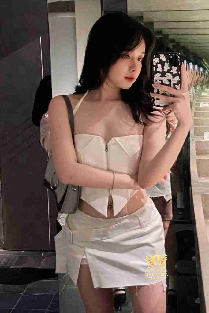 Woman in white halter top and mini skirt taking mirror selfie with phone case.